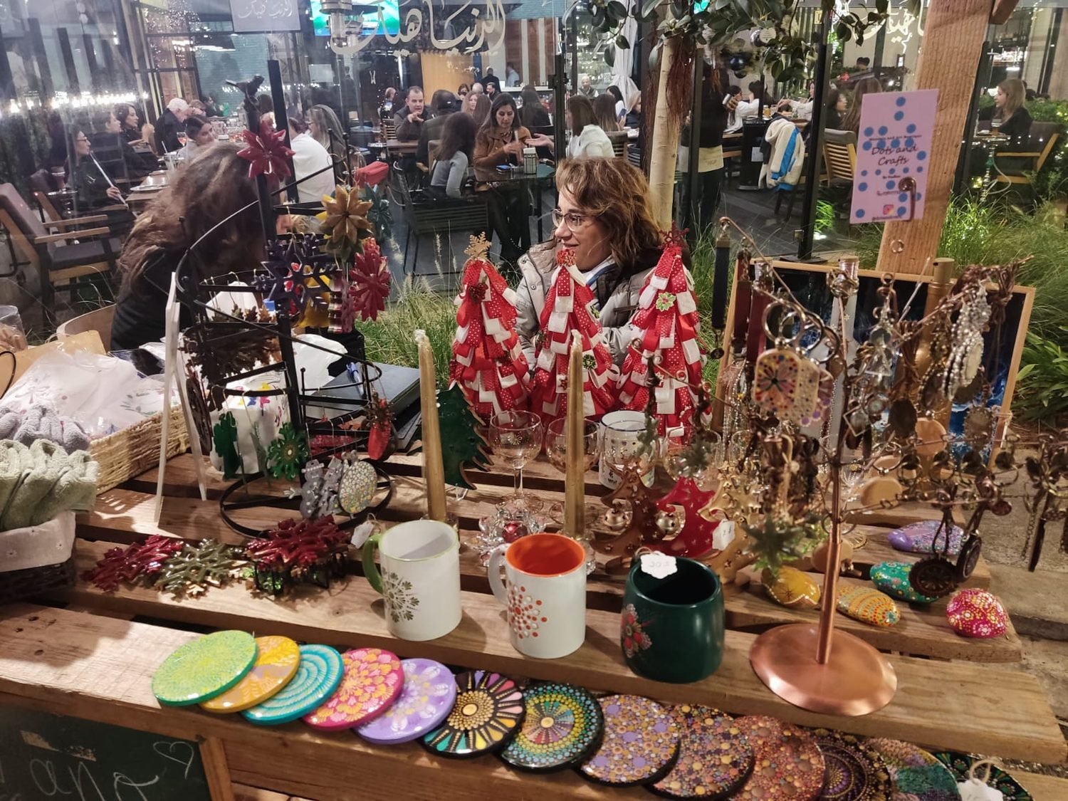 Nadine at her Dots and Crafts stall, surrounded by her hand-painted pieces